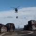 An MH-60R Sea Hawk, with Helicopter Maritime Strike Squadron 37, brings cargo to USS Chung-Hoon (DDG 93), foreground, during a vertical replenishment.