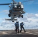 Sailors return to the foul line after attaching cargo to an MH-60R Sea Hawk, with Helicopter Maritime Strike Squadron 37, aboard USS Chung-Hoon (DDG 93) during a vertical replenishment.