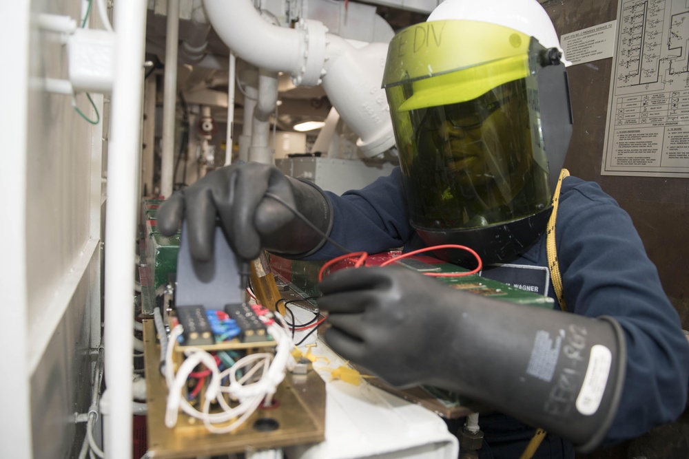 Electrician’s Mate 3rd Class Sasha Wagner uses a voltmeter to ensure power has been secured to solenoids of an aqueous film forming foam (AFFF) station before performing maintenance aboard USS Spruance (DDG 111).
