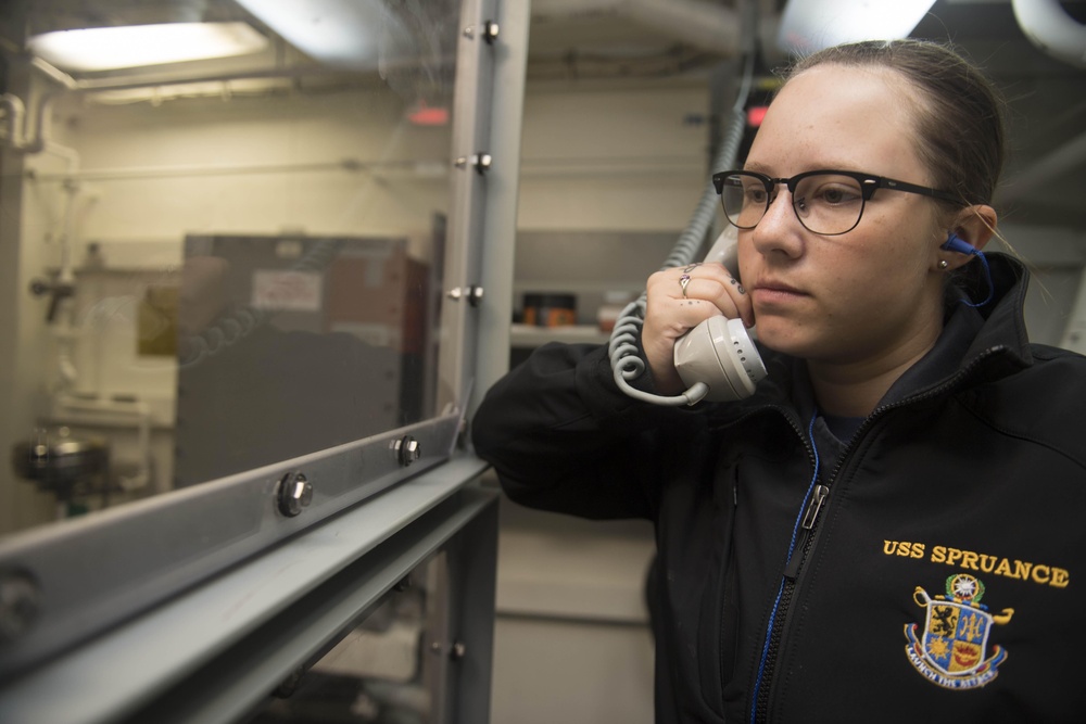 Sonar Technician (Surface) 3rd Class Chelsea Armourmiller stands watch as the phone talker while the the multifunction towed array (MFTA) is retrieved aboard USS Spruance (DDG 111).