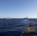 USS Spruance (DDG 111) cuts through the Philippine Sea in formation with USS Mobile Bay (CG 53), left, USS John C. Stennis (CVN 74) and USS Ronald Reagan (CVN 76), and USS Chancellorsville (CG 62), right.