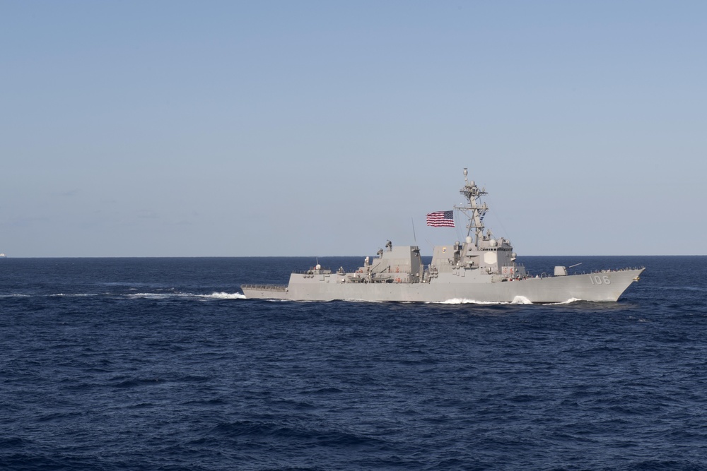 USS Stockdale (DDG 106) cuts through the Philippine Sea while sailing in formation.