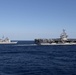 USS Mobile Bay (CG 53) and USS John C. Stennis (CVN 74) cut through the Philippine Sea during formation sailing.