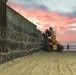 U.S. Border Patrol stands watch during border fence reinforcement