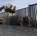 U.S. Border Patrol stands watch during border fence reinforcement