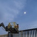 U.S. Border Patrol stands watch during border fence reinforcement