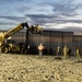 U.S. Border Patrol stands watch during border fence reinforcement