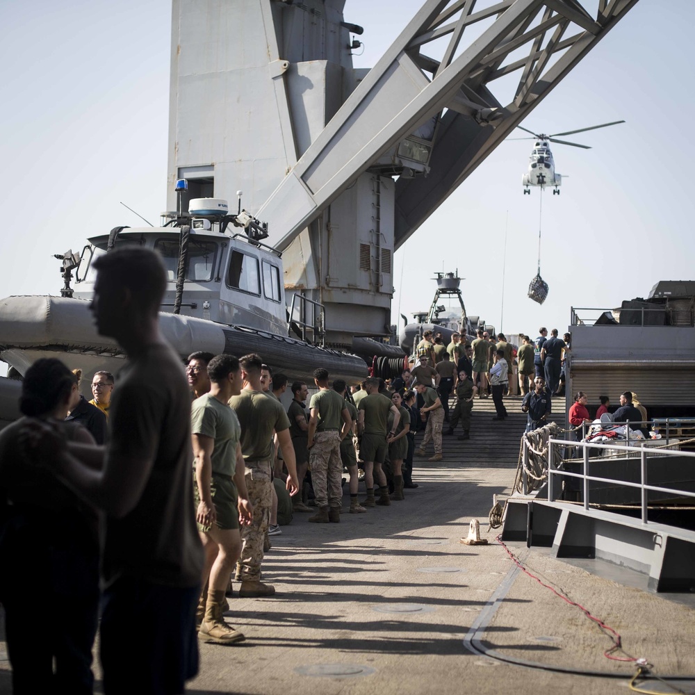 U.S. Marines and Sailors resupply at sea