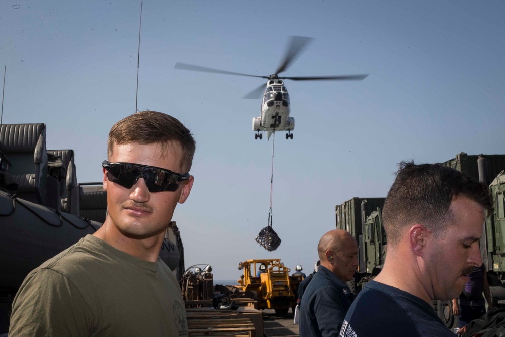 U.S. Marines and Sailors resupply at sea