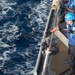 Boatswain’s Mate Seaman Isaiah Rivas hauls in a line at a refueling station aboard USS Chung-Hoon (DDG 93) during a replenishment-at-sea.