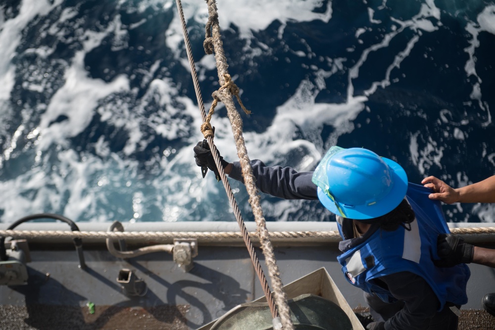 Boatswain’s Mate Seaman Ciara Heath cuts a line at a refueling station aboard USS Chung-Hoon (DDG 93) during a replenishment-at-sea.