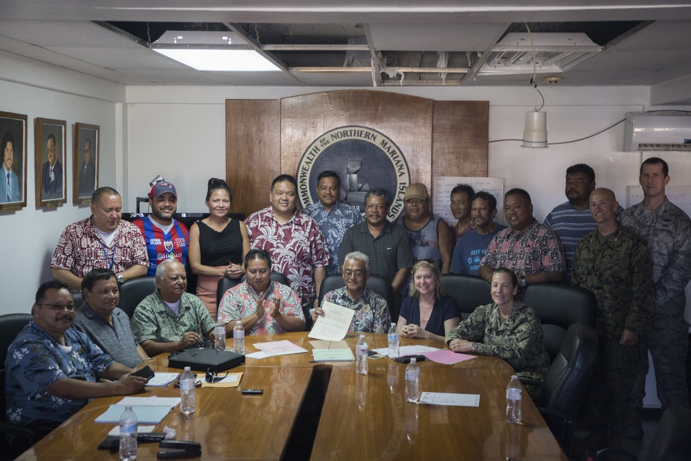 Rear Adm. Chatfield signs airfield divert document with the mayor of Tinian during DSCA relief efforts