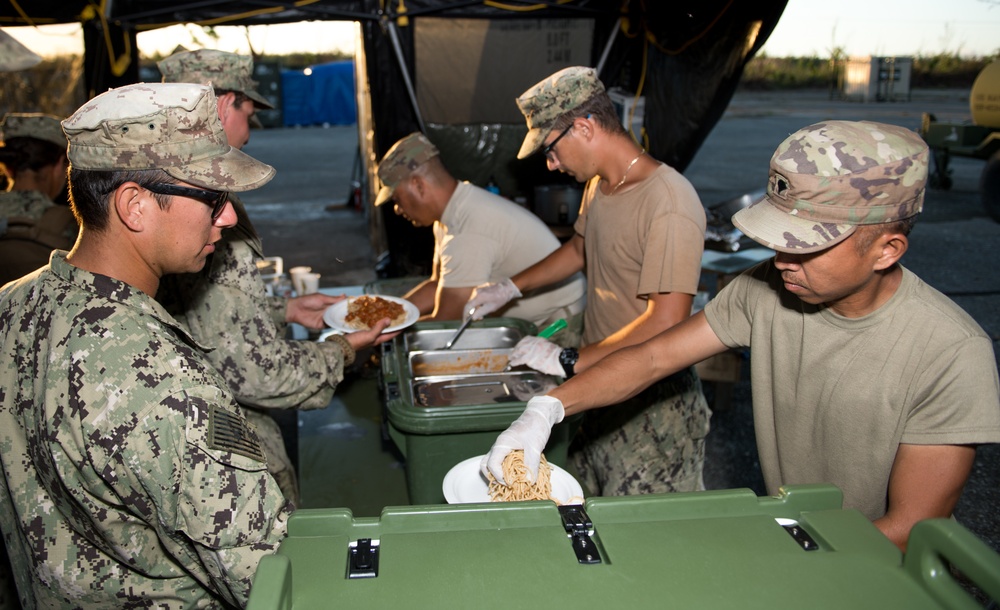 NMCB 1 Sailors and 303rd MEB Soldiers Serve Dinner During Recovery Efforts in Tinian