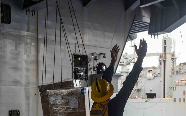 Boatswain’s Mate 2nd Class Norquan Otis directs cargo in the hangar bay aboard USS John C. Stennis (CVN 74) during a replenishment-at-sea.
