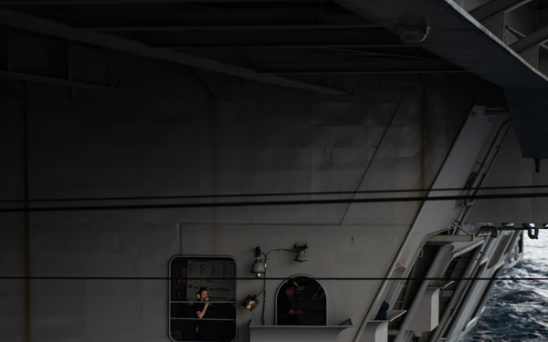 Seaman Recruit Esther Dotson mans a sound-powered telephone aboard USS John C. Stennis (CVN 74) during a replenishment-at-sea.