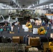 Sailors organize cargo in the hangar bay aboard USS John C. Stennis (CVN 74) during a replenishment-at-sea with USNS Charles Drew (T-AKE 10).