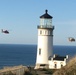 Coast Guard helicopters fly past North Head Lighthouse