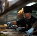 Capt. Randy Peck, commanding officer of USS John C. Stennis (CVN 74), serves Thanksgiving dinner in the aft galley.