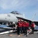 Sailors unload an AIM-120 missile from an EA-18G Growler, with Electronic Attack Squadron (VAQ) 133, on the flight deck aboard USS John C. Stennis (CVN 74).