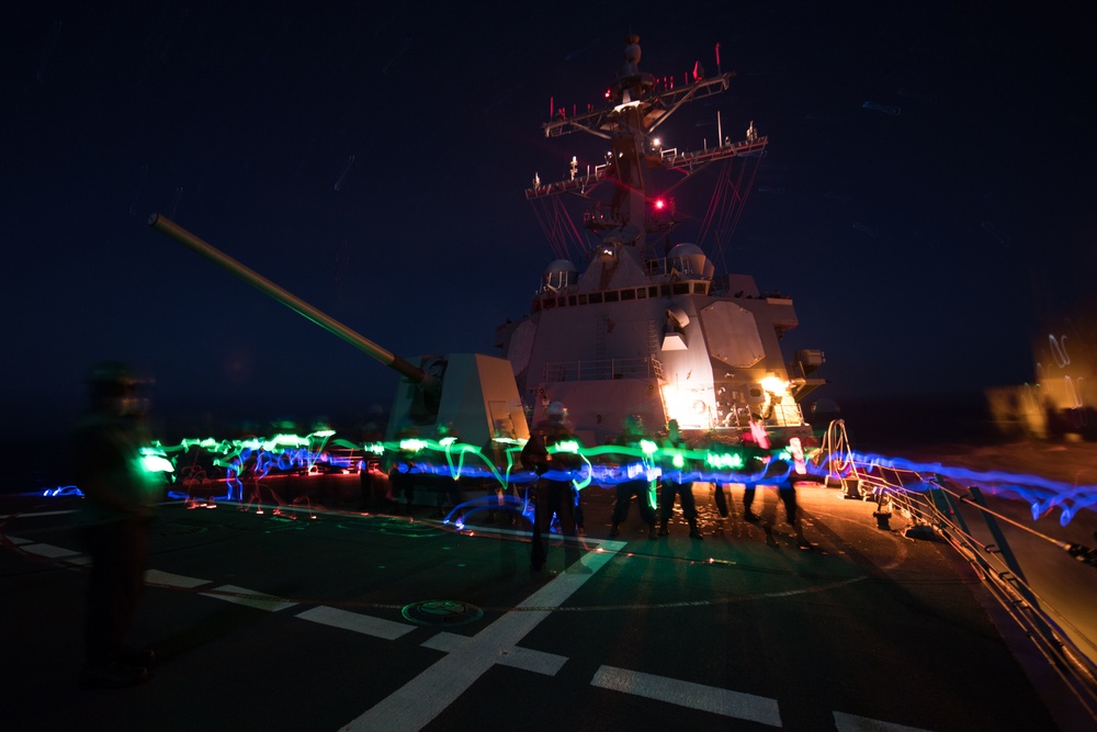 Sailors handle a phone and distance line aboard USS Chung-Hoon (DDG 93) during a replenishment-at-sea.