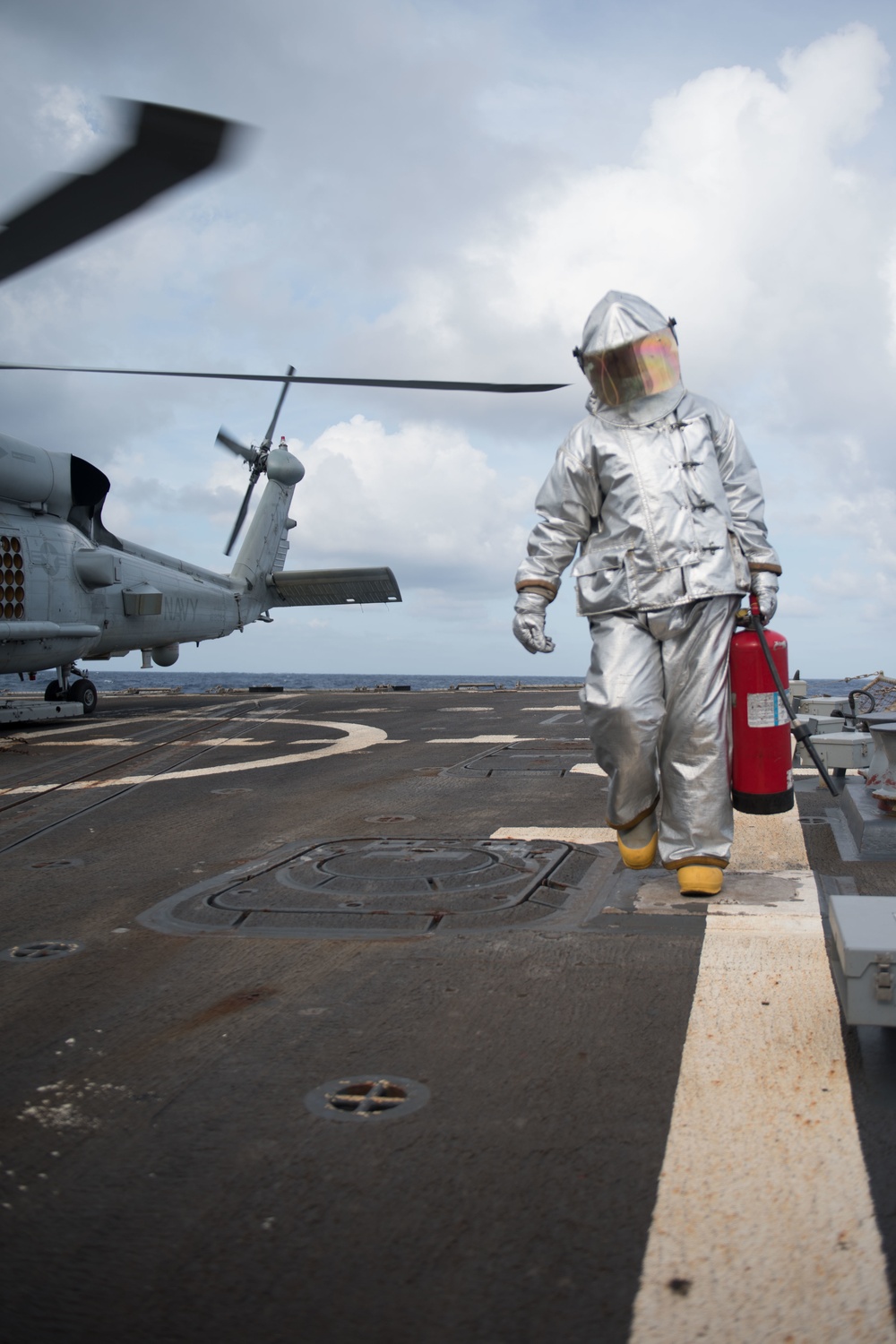 Damage Controlman 3rd Class Sydnie Rodriguez returns to the foul line after refueling an MH-60R Sea Hawk, with Helicopter Maritime Strike Squadron (HSM) 37, aboard USS Chung-Hoon (DDG 93).