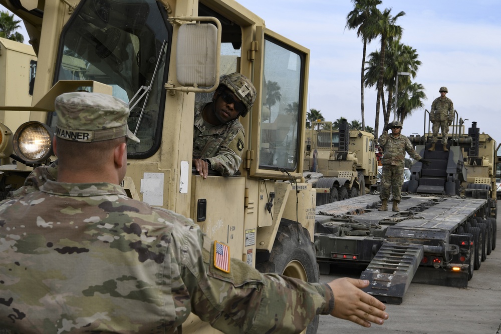 Soldiers load equipment onto trailer