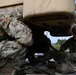 Soldiers load equipment onto trailer