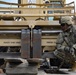 Soldiers load equipment onto trailer