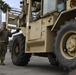 Soldiers load equipment onto trailer