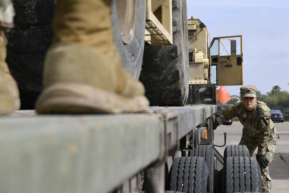 Soldiers load equipment onto trailer