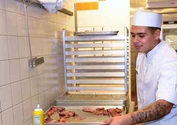 Culinary Specialists from “America’s First Corps” cook all-night long to feed hundreds of Soldiers