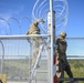 Soldiers Lay Concertina Wire Along Veterans International Bridge