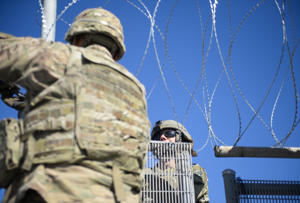 Soldiers Lay Concertina Wire Along Veterans International Bridge