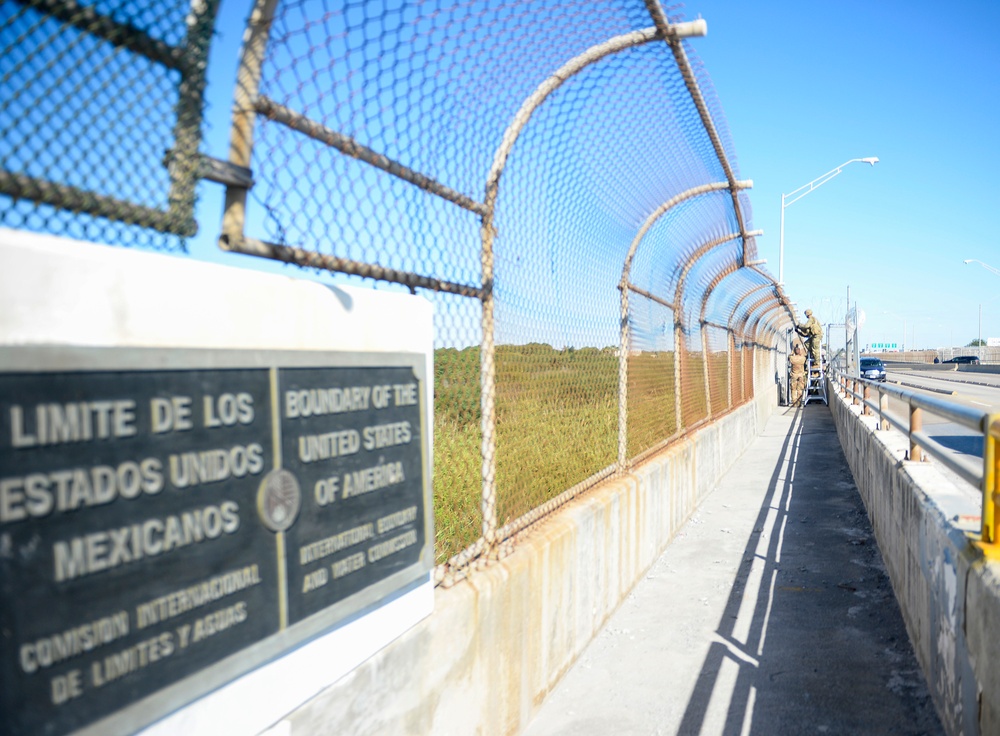 Soldiers Lay Concertina Wire Along Veterans International Bridge