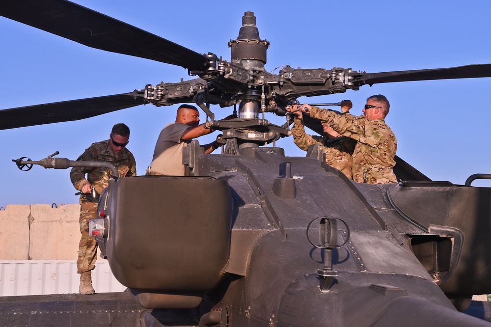 U.S. Army Soldiers assigned to Task Force Panther calibrate and balance the main rotor blades of an AH-64 Apache Helicopter at Kandahar Airfield, Afghanistan Oct 22, 2018.