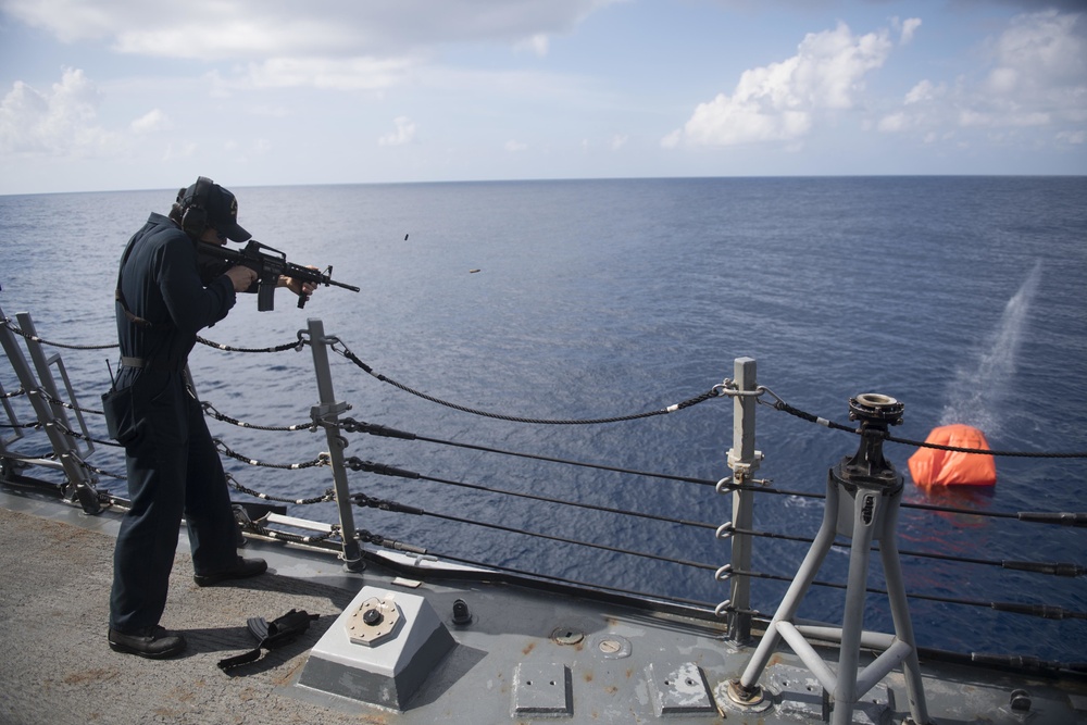 Gunner’s Mate 2nd Class Brandon Diep engages an inflatable target using an M4 carbine during a live fire evolution aboard USS Spruance (DDG 111).