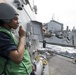 Seaman Laury Champange stands watch as the phone talker aboard USS Spruance (DDG 111) during a replenishment-at-sea.
