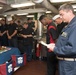 Lt. Bill Gritton, right, gives a prayer before Thanksgiving dinner on the mess decks of USS Chung-Hoon (DDG 93).