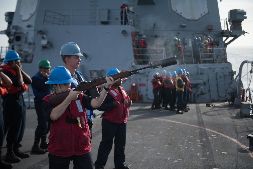 Fire Controlman 2nd Class Chelsea Wolsiefer fires a shot line from USS Chung-Hoon (DDG 93) to USNS Charles Drew (T-AKE 10) during a replenishment-at-sea.