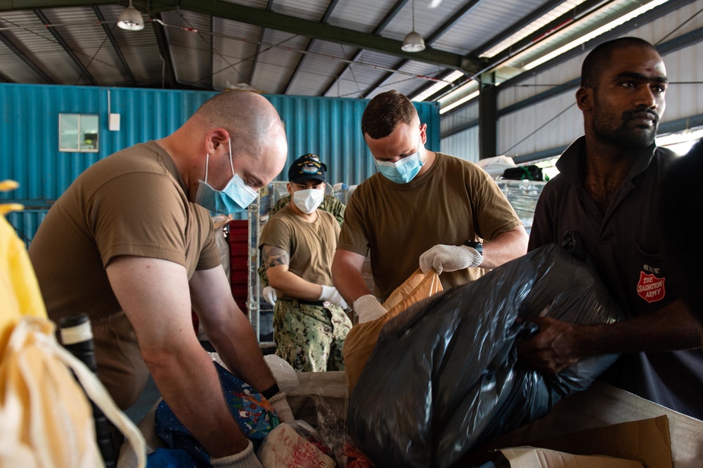 Carrier Strike Group (CSG) 3 Sailors sort donated toys, clothes, and electronics at the Tanglin Salvation Army donation center in Singapore during a community outreach event.