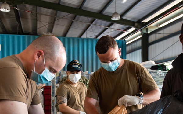Carrier Strike Group (CSG) 3 Sailors sort donated toys, clothes, and electronics at the Tanglin Salvation Army donation center in Singapore during a community outreach event.