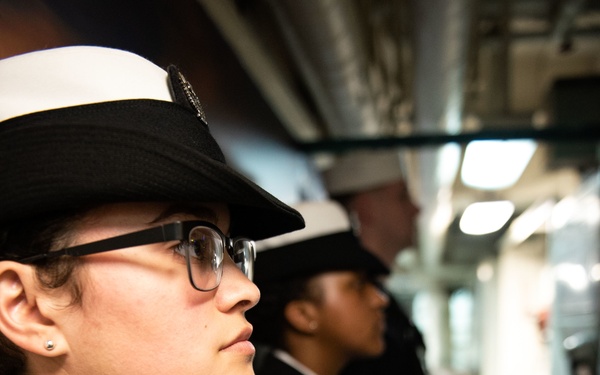 Ship’s Serviceman 3rd Class Stephanie Santana stands at attention before a Sailor of the Year board on the mess decks aboard USS John C. Stennis (CVN 74).