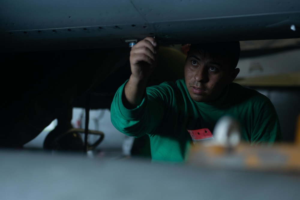 Aviation Structural Mechanic 3rd Class Jurgen Baezabernal removes fasteners while conducting maintenance on an F/A-18F Super Hornet, with Strike Fighter Squadron (VFA) 41, in the hangar bay aboard USS John C. Stennis (CVN 74).