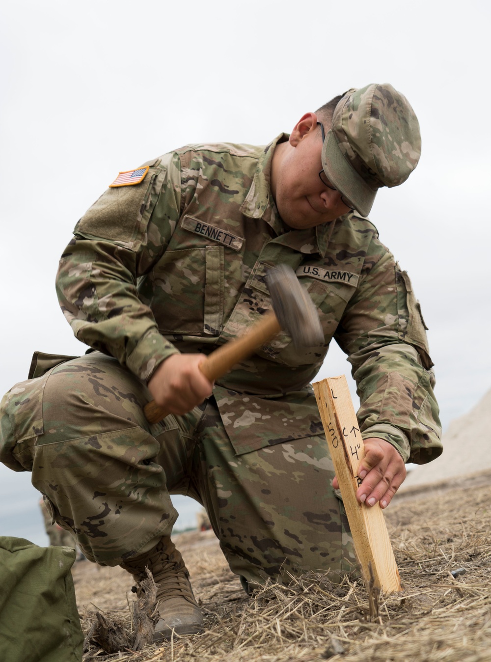 An Engineer Soldier Stakeouts a Roadway for Improvements