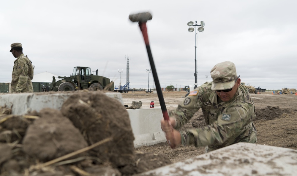 A Soldier Hammers a Post for Ramp Construction