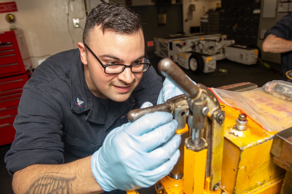 Aviation Support Equipment Technician 3rd Class Mohsen Valadanzouj, from Knoxville, Tennessee, troubleshoots an aircraft axle jack in the gas systems equipment shop aboard the Nimitz-class aircraft carrier USS John C. Stennis (CVN 74).