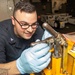 Aviation Support Equipment Technician 3rd Class Mohsen Valadanzouj, from Knoxville, Tennessee, troubleshoots an aircraft axle jack in the gas systems equipment shop aboard the Nimitz-class aircraft carrier USS John C. Stennis (CVN 74).