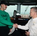 Aviation Support Equipment Technician 3rd Class Garrett Rains receives a Commanding Officer’s coin as the Sailor of the Day, from Commanding Officer Capt. Randy Peck, aboard USS John C. Stennis (CVN 74).