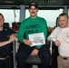 Aviation Support Equipment Technician 3rd Class Garrett Rains, center, poses for a photograph as the Sailor of the Day with Capt. Randy Peck, right, commanding officer of USS John C. Stennis (CVN 74), and Command Master Chief Benjamin Rushing.