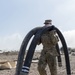 A Soldier Hauls Fuel Lines for Storage